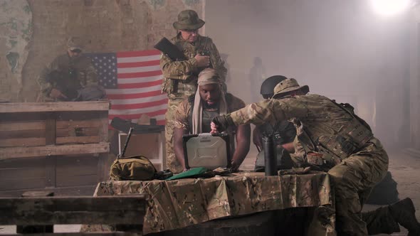 US Military Men Discovering Enemy Using Laptop alt