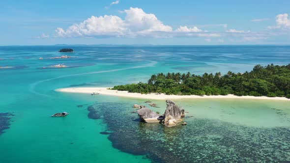 Aerial landscape panning shot of beautiful tropical islands and turquoise blue ocean on a sunny day alt