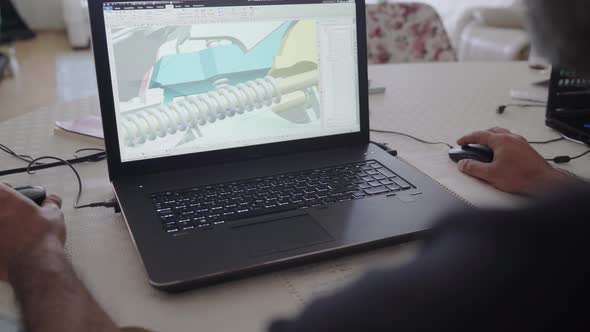 3d graphic designer is working on a rifle concept with a hi-tec mouse. alt