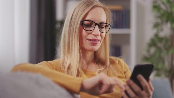 Woman Using Mobile on Couch