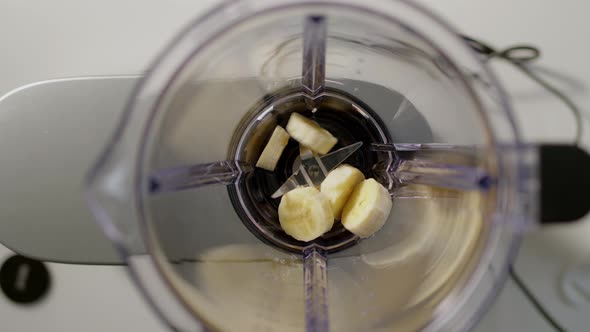 Banana Chunks are Thrown Into Blender to Make Smoothie alt