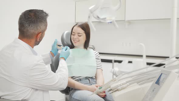 Young Woman Learning About Dental Care From Her Dentist