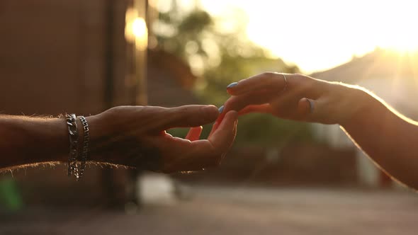 hands of romantic couple a close-up. hands men and women symbol love teamwork sunlight happy family 