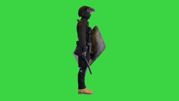 Special Unit Riot Policeman with a Shield and Baton Standing Waiting on a Green Screen Chroma Key alt