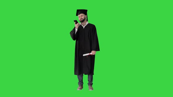 Mature Man Graduate Student Recording Voice Message on a Green Screen, Chroma Key. alt