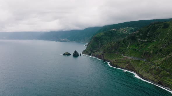 Aerial along Porto Moniz steep and rugged rocky coastline, Madeira, Portugal alt