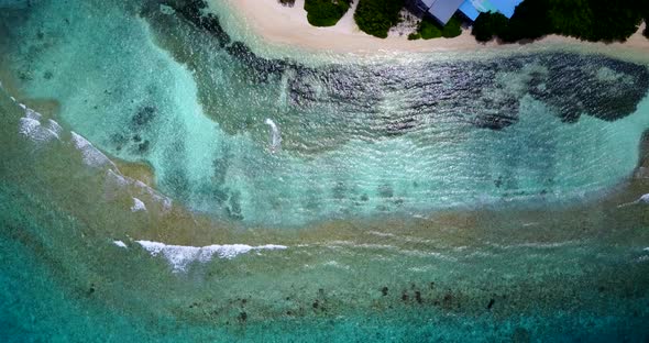 Luxury birds eye travel shot of a white paradise beach and blue sea background in vibrant  alt