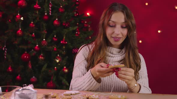 Young Pretty Woman Making Xmas Cookies Decoration for New Year Family Dinner