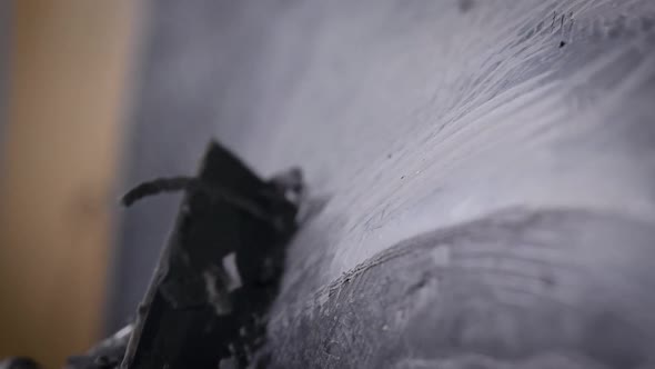 Sculptor Is Polishing Industrial Sample From Black Modeling Clay in Workshop Making Models for alt