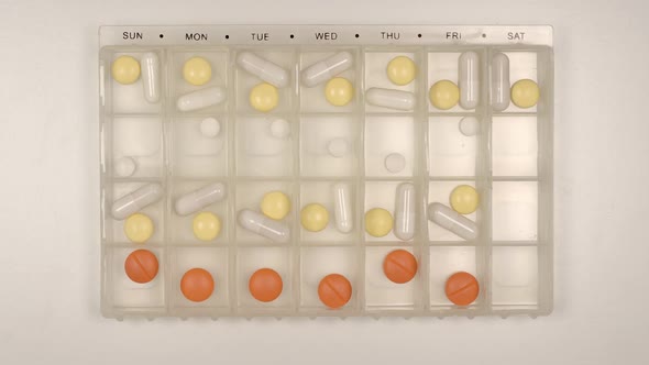 Pills fill a plastic organizer