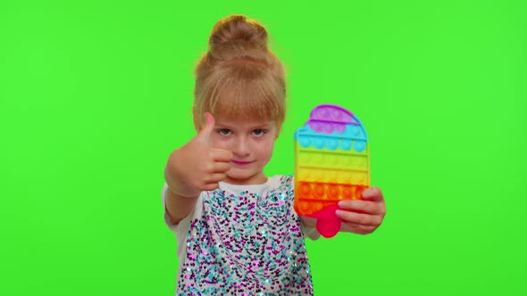 Stylish Cute Little Child Kid Play with Trendy Pop It Bubble Squishy Sensory Toy Game on Chroma Key alt