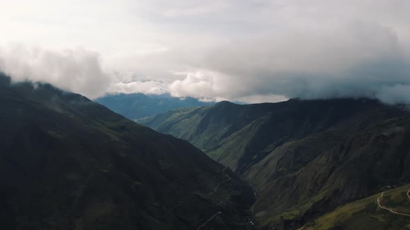 Aerial view through Andes Mountains with sky and clouds in Peru 4K