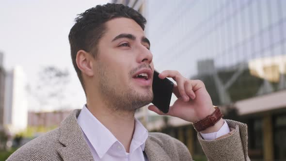  Attractive Businessman Talking on Mobile Phone alt