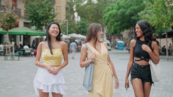 Overjoyed Women of Different Races Best Friends Strolling Along City Street Together and Laughing alt
