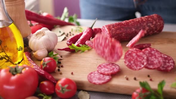 Sausage Slices on the Wooden Cutting Board at Domestic Kitchen alt