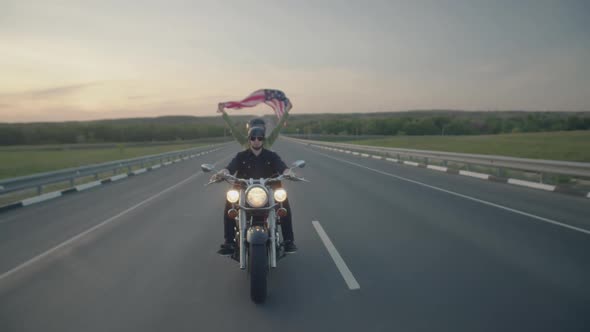 Man and Woman in Hard Hats are Riding a Motorcycle on Highway alt