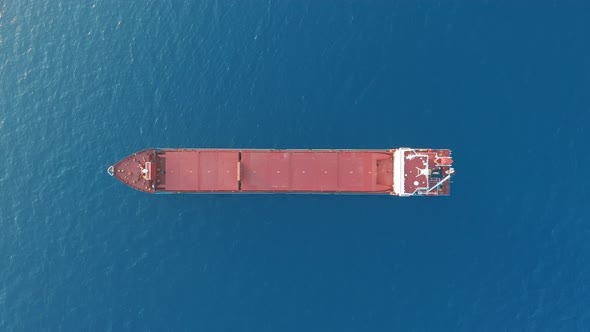 Freight Ship Floating on Sea. Aerial View. alt