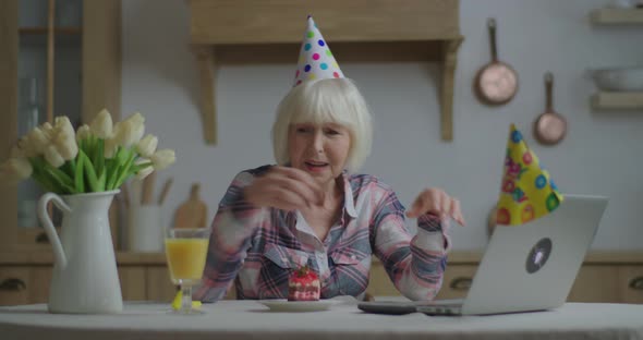 Cheerful Senior Woman Congratulates Friend with Birthday Online with Laptop, 70s Woman in Birthday alt