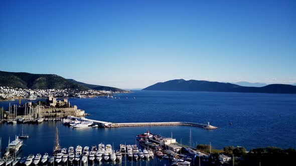 View from drone on full of yachts Bodrum harbour and ancient Kalesi castle in Mugla in Turkey alt