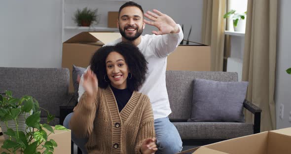 Happy Interracial Couple Afro American Woman and Caucasian Man Homeowners Sitting Together on Couch alt