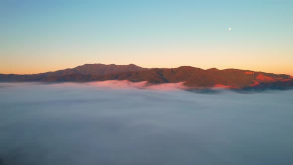 4K Aerial video Beautiful sunrise above dense clouds and fog in the morning alt