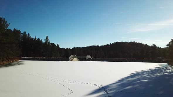 Huge frozen white lake in Colorado, drone flying up and revealing more of the frozen lake. alt