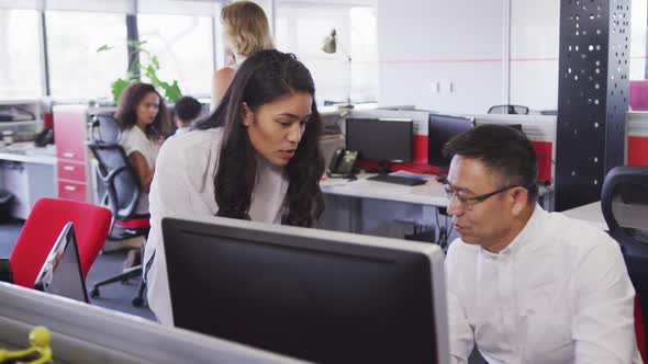 Senior businessman discussing with young businesswoman in modern office in slow motion alt