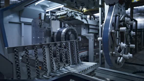 Tire Factory Employee Working with Modern Industrial Machine Taking Production alt