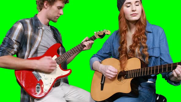 Musicians playing guitars alt