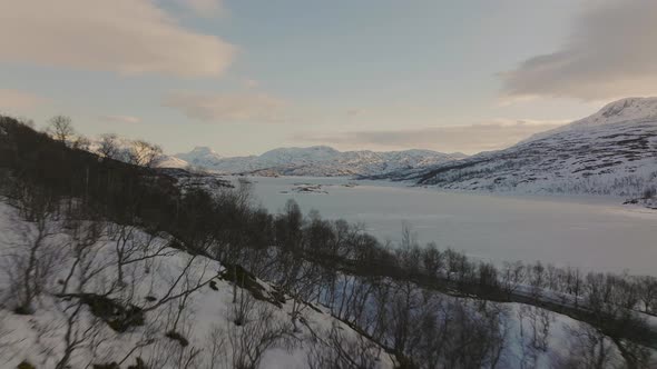 Snowy white winter landscape - scenic road next to frozen lake ...