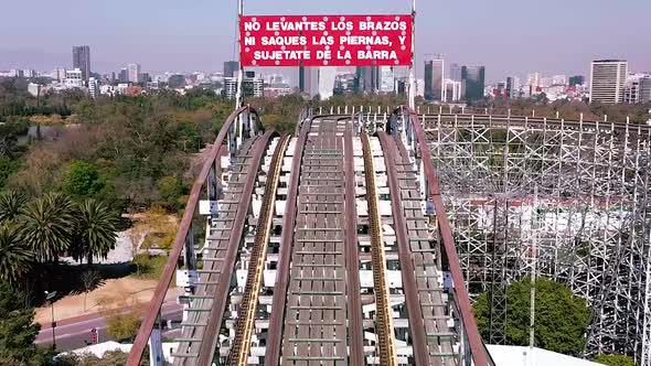 Drone footage roller coaster in Mexico with a building wiew background alt