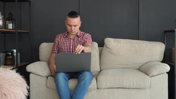 Freelancer Using Gray Laptop Sit on Couch