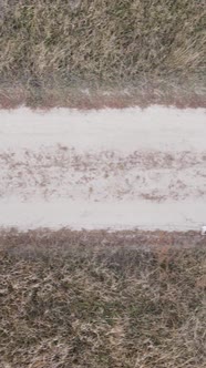 Vertical Video a Dirt Road Through an Empty Field alt