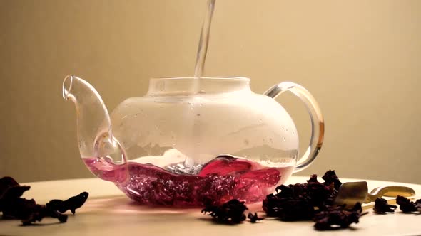 Water Puring in Teapot with Red Karkade Tea