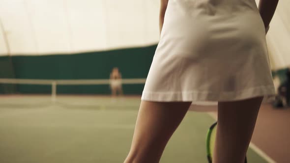 Backside From Bottom Upward Footage of an Active Female Tennis Player Hitting the Ball with Racket alt