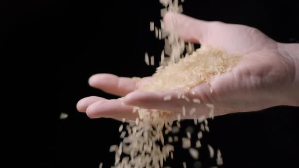 Rice falling in hand slow motion