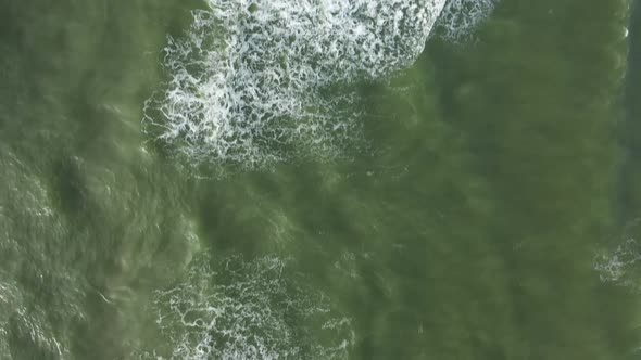 AERIAL: Top View Ascending Shot of Waves of Baltic Sea on Windy Day