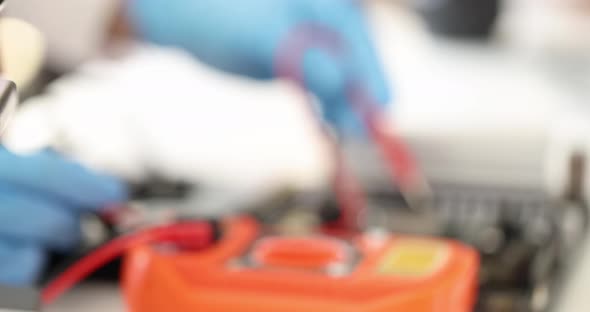 Master Putting Tester Probe Into Computer Motherboard  Movie Slow Motion alt