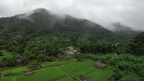 Aerial view of rural village in valley, Chiang Mai, Thailand by drone