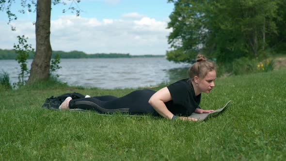 Young Girl Exercising By the Lake