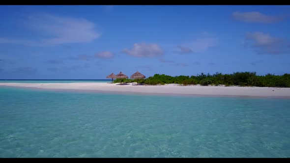Aerial above seascape of idyllic bay beach lifestyle by transparent water with white sand background alt