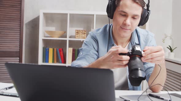 Workplace of freelance worker at home office. Young man works using computer. alt