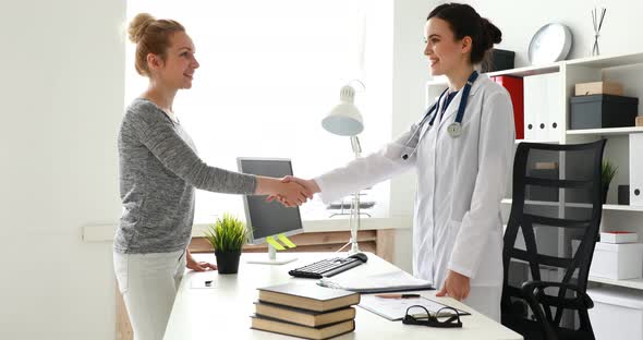Doctor and Patient Shake Hands in Office.
