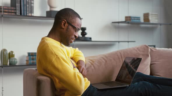 Young man calling with webcam at the desk at home office. Man doing video chat alt
