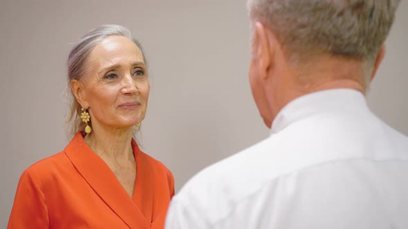 Senior Couple Talking and Hugging. Mature Woman Embracing Husband and Smiling