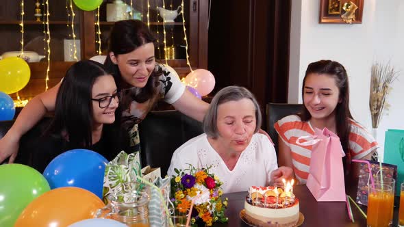 Senior Mother with Daughter and Granddaughters at Birthday Party