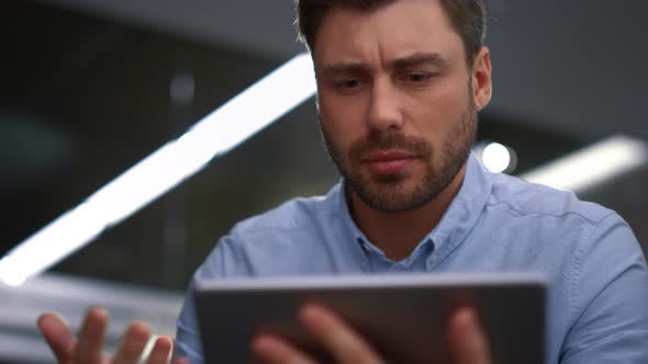 Serious Entrepreneur Talking Tablet Calling Video Chat Online in Company Office alt