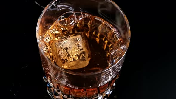 Slow Motion Shoot On Ice Cube Dropping Into The Whiskey