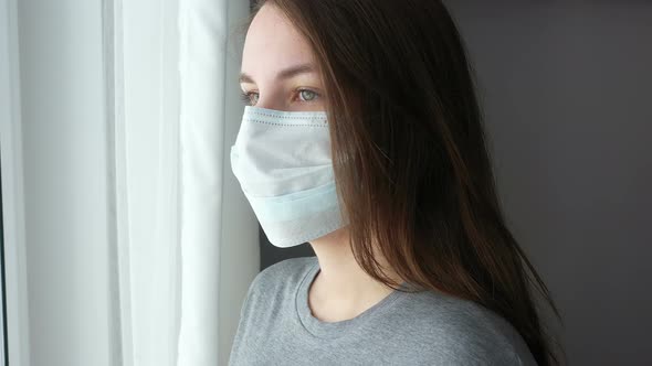 Woman Looking out The Window and Take Off Face Mask from Face.