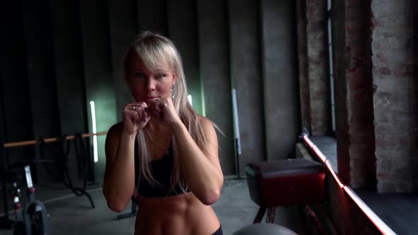 Young Pretty Woman Is Training in Gym, Workout and Box Fighting for Strong and Endurance alt